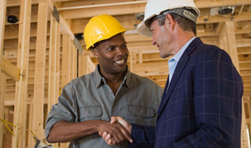 men in hard hats shaking hands